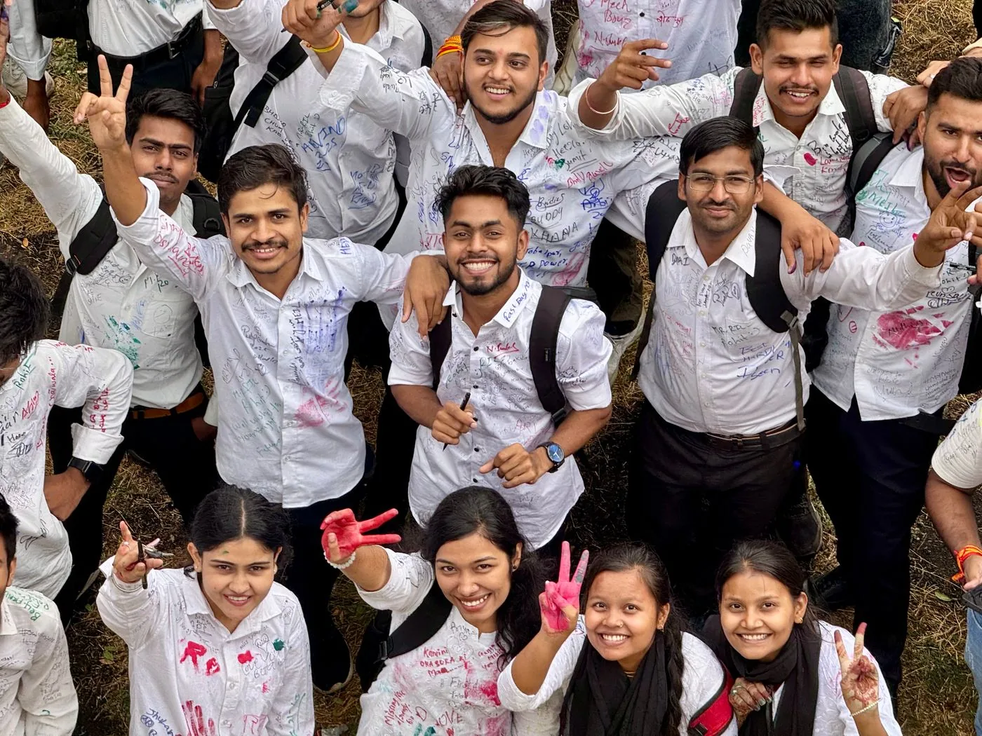 Happy students celebrating their success outdoors
