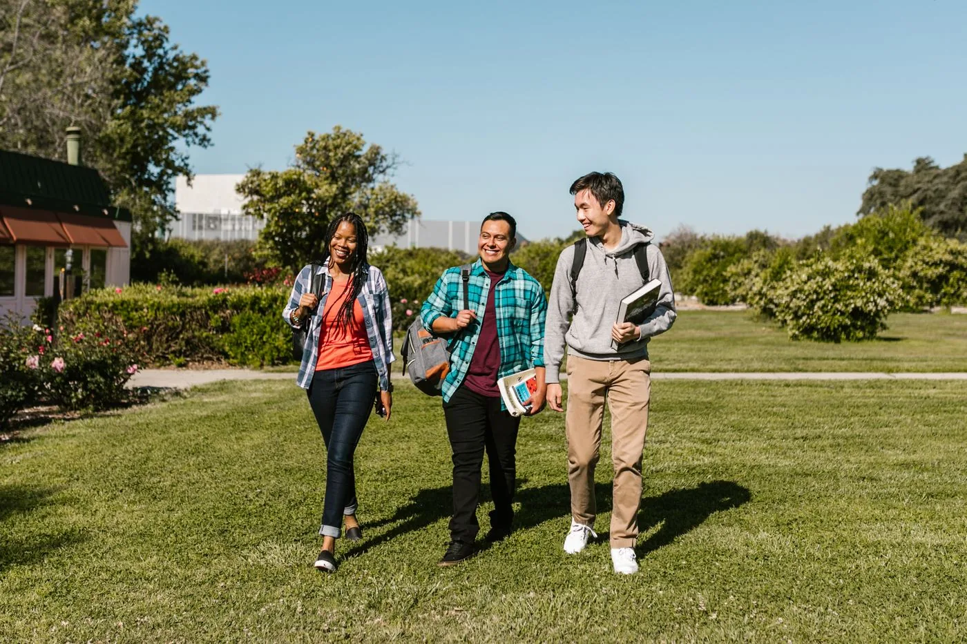 Students walking together on the campus lawn