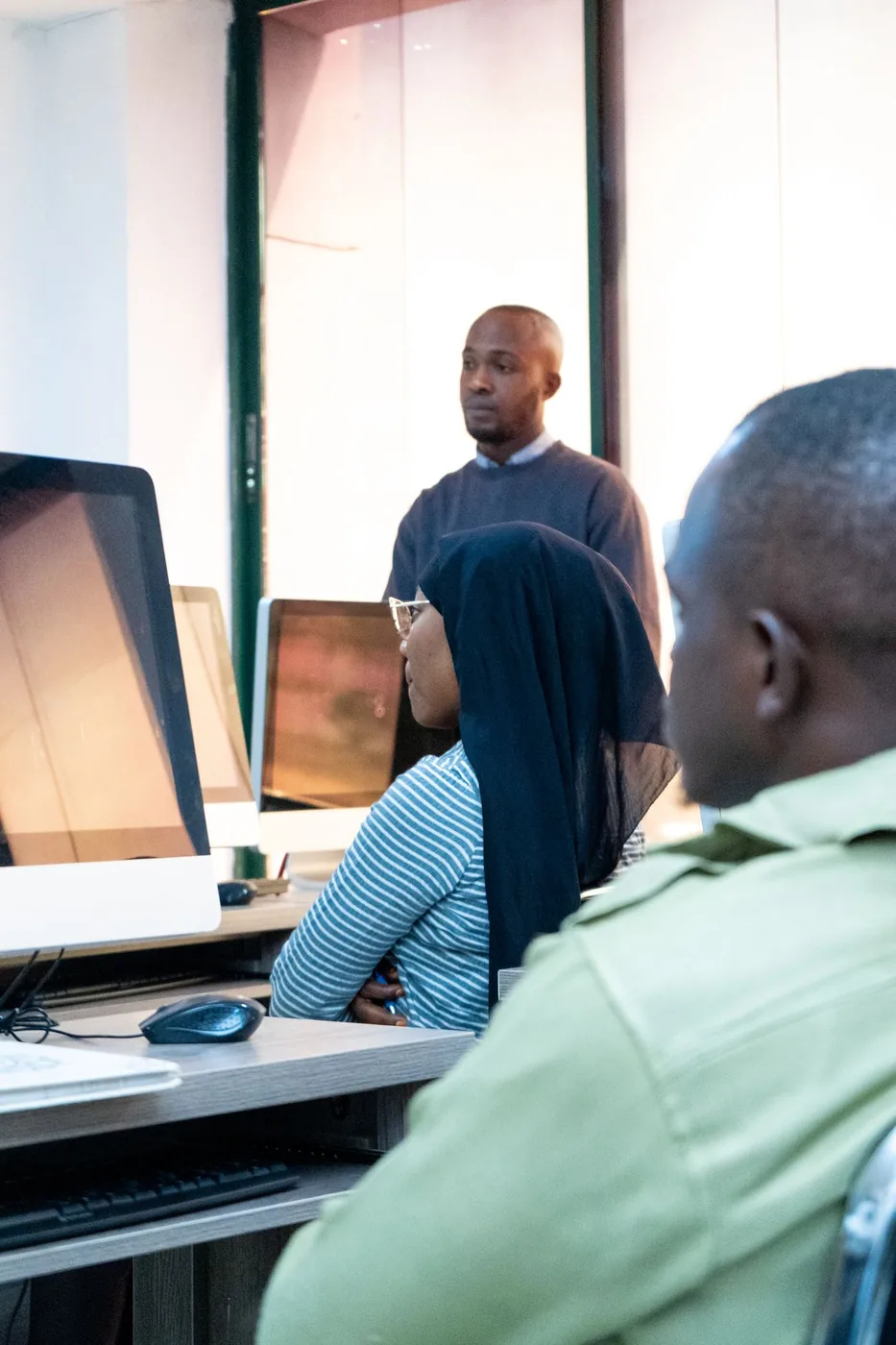 A group of students working together in a programming session